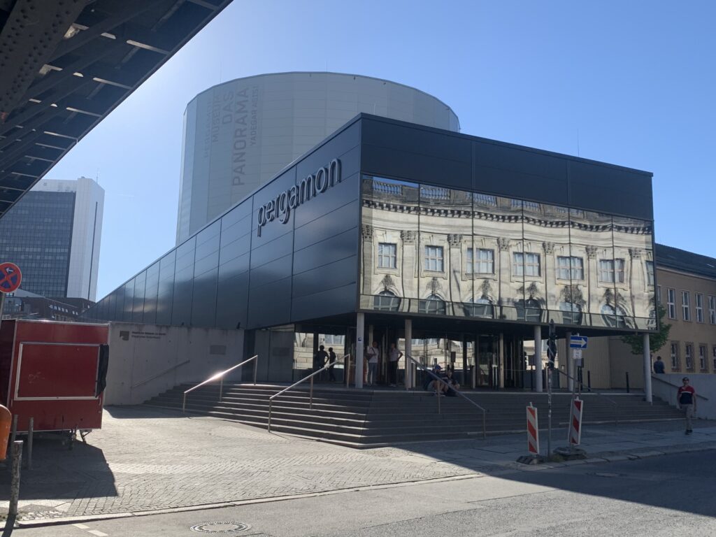 A square building with a circular tube in the back