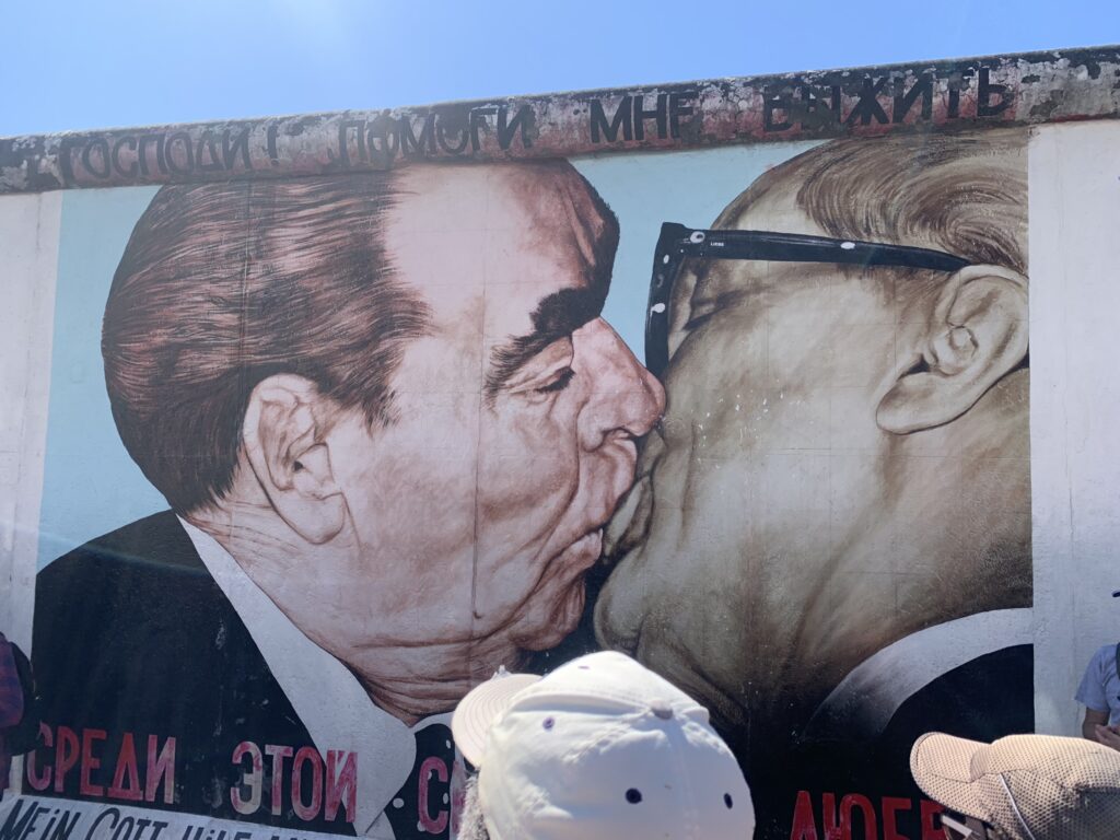 two men in suits kissing