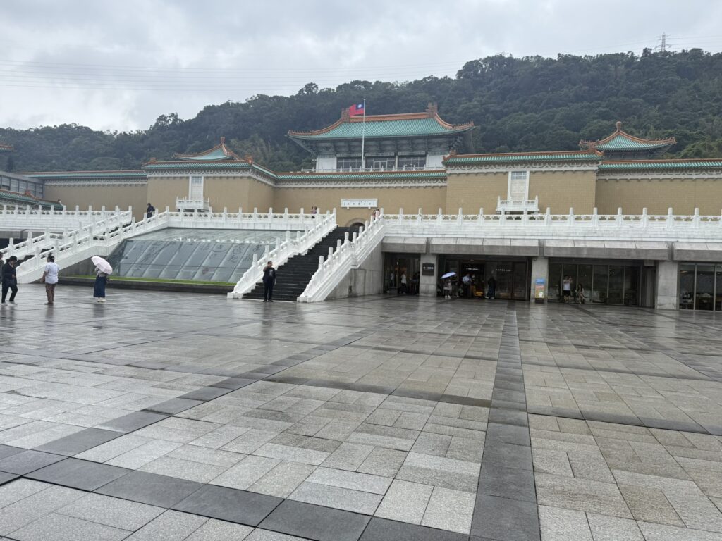 Black stairs and white fence leading to the palace